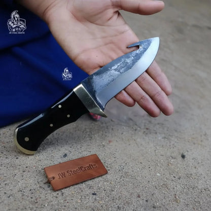 Gut hook knife with wood and brass handle.